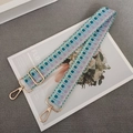 Close-up of mint green and purple woven strap with golden metal lobster clasps - Light Green Purple + Gold Hook