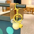 Yellow mouse-shaped liquid quicksand keychain with yellow bell and brown leather strap - Yellow Mickey Head Milk Bean