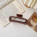 Detail view of a large brown matte rectangular claw clip on a stylish table setting - Matte Large Square Coffee