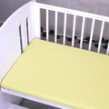 Pale yellow cotton fitted crib sheet with elastic edges on a white wooden infant bed - Light Yellow / 120*60cm