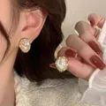 Elegant 925 silver needle gold earrings featuring irregular pearls and vintage texture - Retro Gold Wrapped Mother of Pearl Irregular Stud Earrings