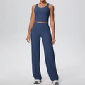 Detail view of navy blue yoga set featuring a U-neck vest and wide-leg training pants - S / Navy Blue