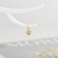 Detailed view of an eight-pointed star charm with pink zircon in gold plating - Gold with Pink Zirconia