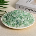 Natural green aventurine crystal chips in a white dish with botanical background - Green Fluorite (7-9mm) 100g