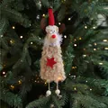 Plush reindeer Christmas ornament with red knit hat and star detail on tree branch - Long Plush Reindeer C