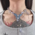 Close-up of Y2K style necklace featuring a large blue butterfly pendant and clear beads - Blue Crystal Butterfly Necklace X3906