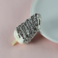 Realistic artificial white cream popsicle with chocolate sauce and coconut shavings - Brown