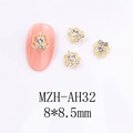 Macro view of 8x8.5mm golden crown nail charms with rhinestones on a pink nail tip - Crown Style (AH32)