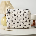 Quilted white cosmetic bag with black bow pattern and elegant pearl zipper pull detail - Medium / White Black