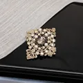 Close-up of Style E vintage baroque brooch with brown gemstone and micro-set pearls - Style E Retro Coffee Gold