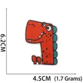 Detailed view of an orange embroidered dinosaur patch with size dimensions 6.2cm by 4.5cm - No. 5 (Red Blue White Dinosaur)