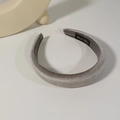 Detail showing hand made label on silver velvet padded headband with soft shadows - Gray