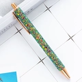 Chic glitter ballpoint pen with rose gold metallic accents on a grid background - Sequin Gradient