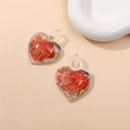 Macro view of heart-shaped glass pendant with orange flowers and gold leaf foil detail - Red (Type C)