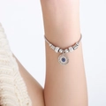 Silver snake chain bracelet featuring a blue evil eye pendant and crystal charms - Greek Key Evil Eye Style (E445) / Steel