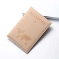 Detail of world map embossed pattern on a beige PU leather travel passport cover - Khaki