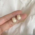 Elegant gold rectangular stud earrings with cream spiral inlay held by hand for scale - Retro Rectangle (A187 Gold)
