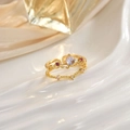 Anillo corona de lujo con gema arcoíris y piedras rojas sobre fondo de seda elegante - Diseño Corona Piedra Arcoíris (JZ0110)