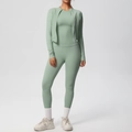 Detail of sage green three-piece yoga set with zip jacket, vest and high waist leggings - S / Basil Green