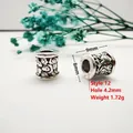 Macro detail of antique silver spacer beads with engraved cloud patterns and dimensions - Style 12 (Auspicious Cloud)