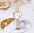 Close-up of elegant gold watch with white Roman dial and beige slim leather strap - Beige