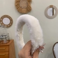 Detail view of the soft white plush texture and durable headband material - Off White