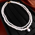 Close-up of double-layer faux pearl necklace with zircon pendant on black jewelry box - Double Layer Pearl Style / White