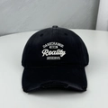 Distressed black baseball cap featuring white Reality embroidery and torn brim details - One Size (58-60cm) / Black