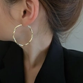 Close-up of a large twisted gold hoop earring on model showing metallic texture - Small Twisted Hoop (15# Silver Earring Post-Gold)