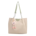 Cream tote bag with green straps and a cute plush monster charm shown in front view - Green - With Charm