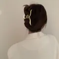 Elegant matte gold butterfly hair claw clip with hollow heart design worn on brown hair - Heart Hollow Wave Style / Large / Matte Gold