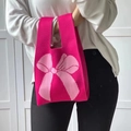 Knitted tote bag in vibrant rose red featuring a soft pink oversized bow pattern - Rose Red Bow