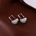 Macro detail of silver U-shaped zircon earrings with sparkling pave-set stones on satin - Ear Buckle / Silver