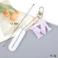 Purple marble acrylic letter M keychain with silver hardware and white tag, 13.5cm long - Letter M