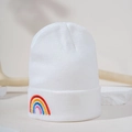 Detail of white knit beanie showing colorful rainbow embroidery and warm texture - Embroidered Rainbow - White