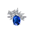 Macro view of blue oval gemstone ring with cluster pear-cut diamond halo on silver band - US 5 / Blue Oval Gem