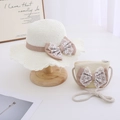 Detail view of girls straw hat and matching bag set with lace bows and wavy edges - Milk White Set