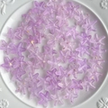 Close-up of purple gradient acrylic starfish beads with gold glitter for DIY jewelry making - Purple