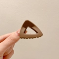 Minimalist matte brown triangle hair claw clip for women shown in a hand - 9# Triangle Light Coffee