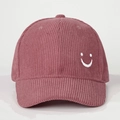 Detailed close-up of pink corduroy baseball cap featuring a white embroidered smiley face - Embroidered Smile / Dusty Pink