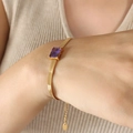 Golden snake chain bracelet featuring a rectangular purple zircon gemstone with adjustable clasp - Purple Zirconia Gold Bracelet (E377)