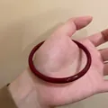 Elegant deep burgundy resin bangle bracelet with high gloss finish on woman's wrist - Vermilion Bangle #sz406