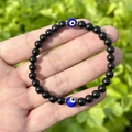 Elastic beaded bracelet with black natural stones and blue evil eye glass charms - 6MM Shiny Stone + Evil Eye + Silver Bag
