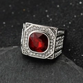 Macro shot of 316L stainless steel men's ring with large ruby red stone and pavé gems - Steel Red Stone