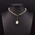 Golden necklace with small white pearls and baroque pearl pendant on black display stand - Baroque Large Pearl Multi-way Adjustable Necklace