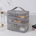 Three-piece set of grey mesh travel toiletry bags with zipper and handle on marble top - Triple Layer / Gray