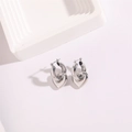 Minimalist silver heart charm hoop earrings with elegant polished metallic finish - Silver Hollow Style