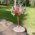 Handmade wire tree of life with colorful crystal leaves on an agate slice base - Rainbow
