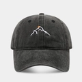Macro detail of mountain embroidery on washed cotton baseball cap with orange sun accent - Adjustable / Black