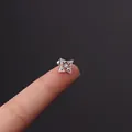 Star zircon stud earring in silver steel with ball screw back on model's hand - Zircon Four-Pointed Star (HSPJ356-11#)